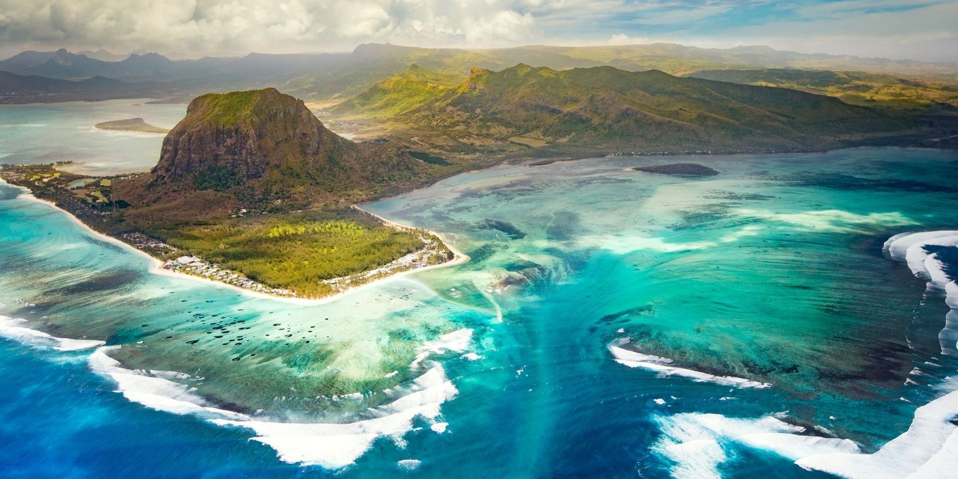An aerial view of a mauritius island in the middle of the ocean.