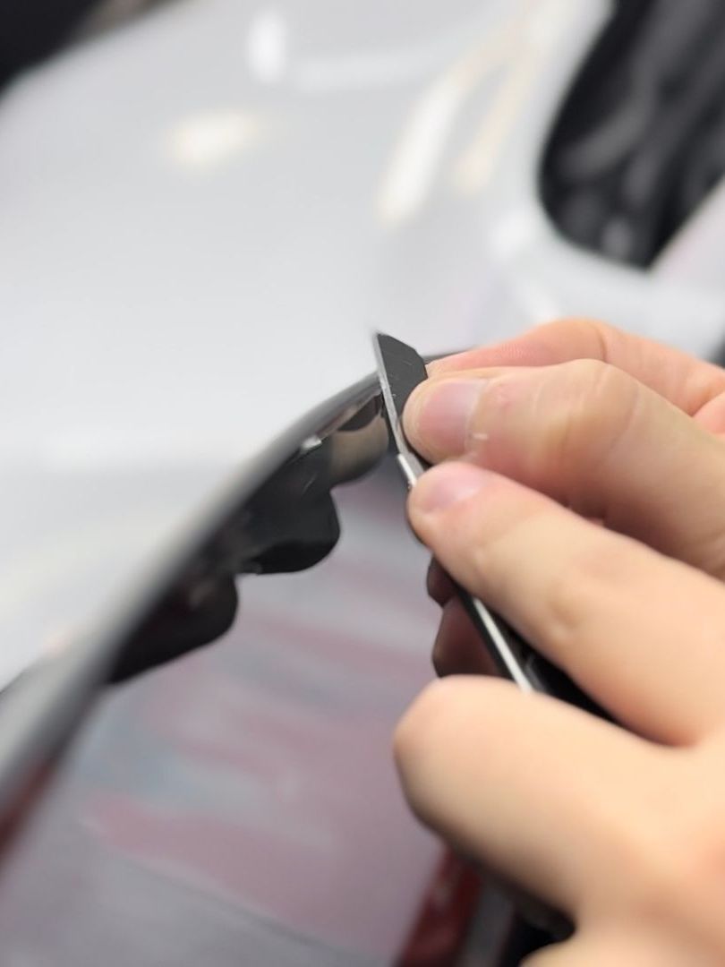 A close up of a person holding a pair of scissors