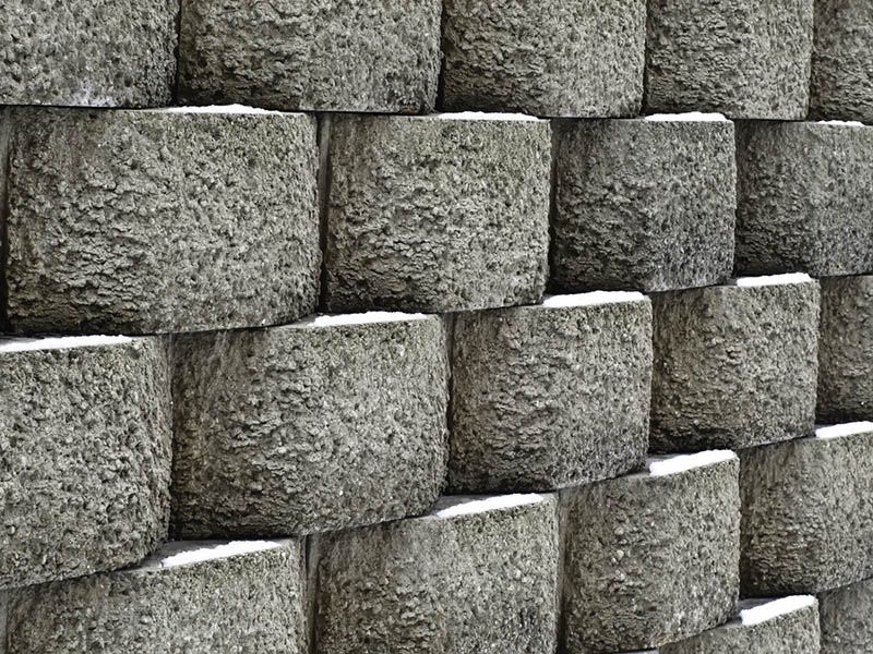A Close Up Of A Stone Wall Made Of Concrete Blocks — DCK Concreting In Lake Cathie, NSW