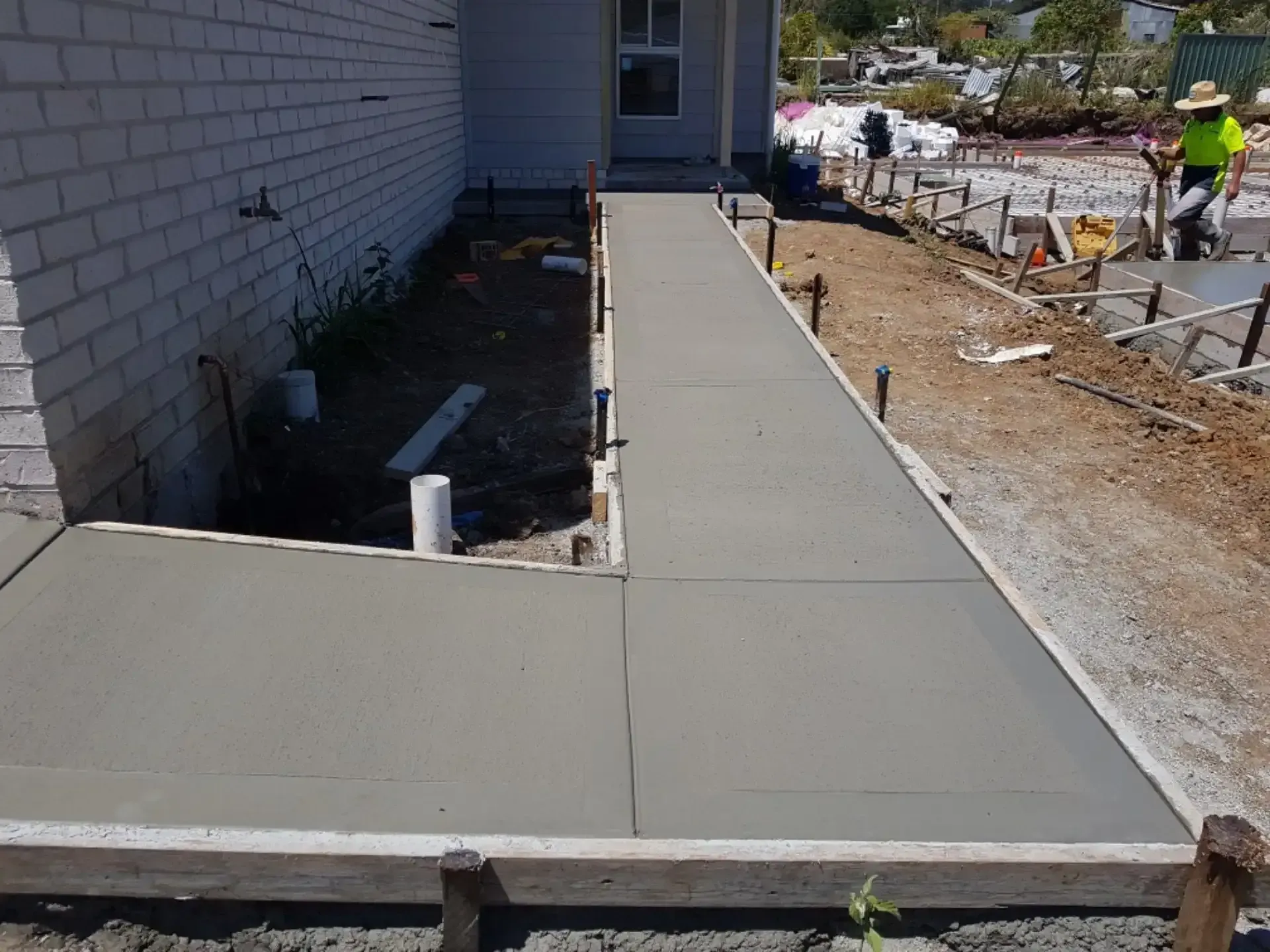 A Concrete Walkway Is Being Built In Front Of A House — DCK Concreting In Lake Cathie, NSW