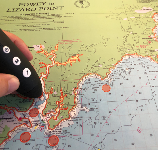 A picture of one of the talking and touchable charts produced by Imray available from SVT. The chart is of Southern Cornwall. A talking pen is being held on one of the descriptive spots.