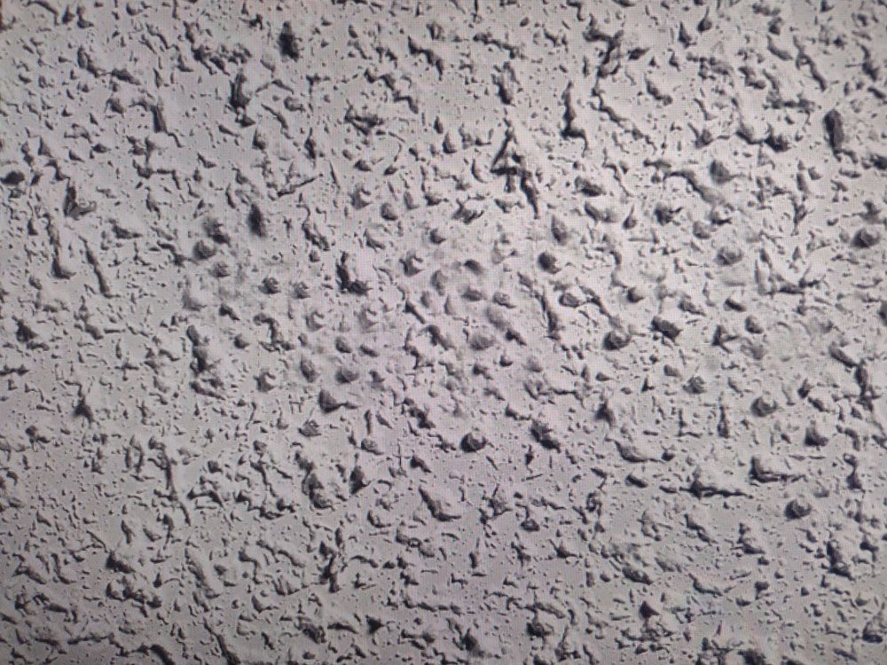 A close up of a gray surface with a lot of small dots on it.