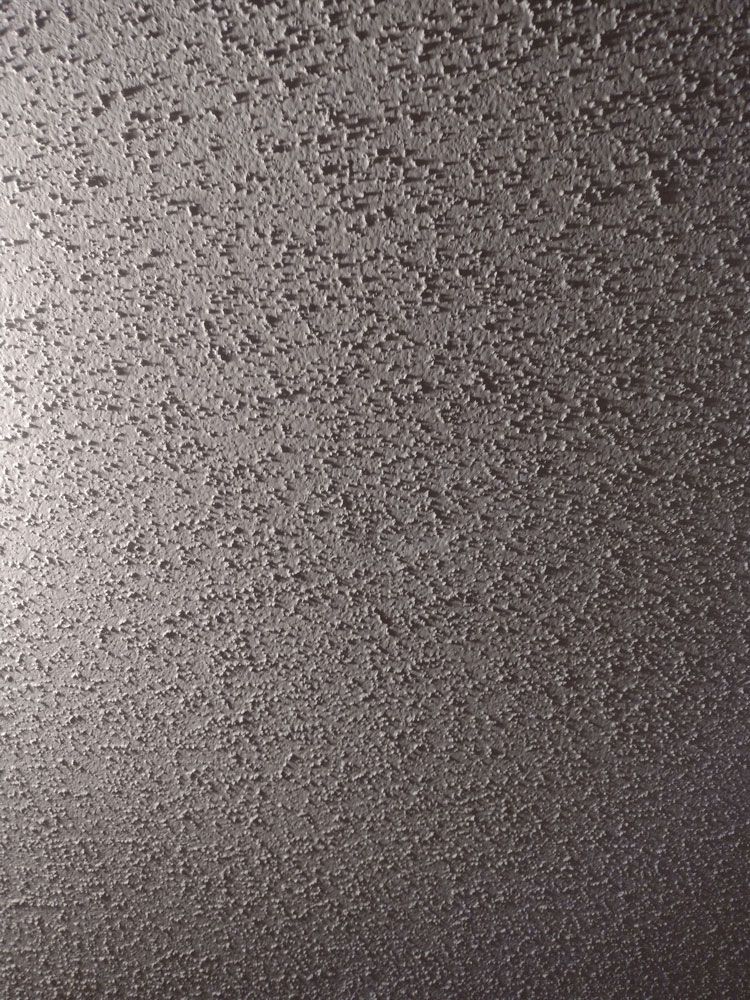 A close up of a metal surface with a grainy texture.