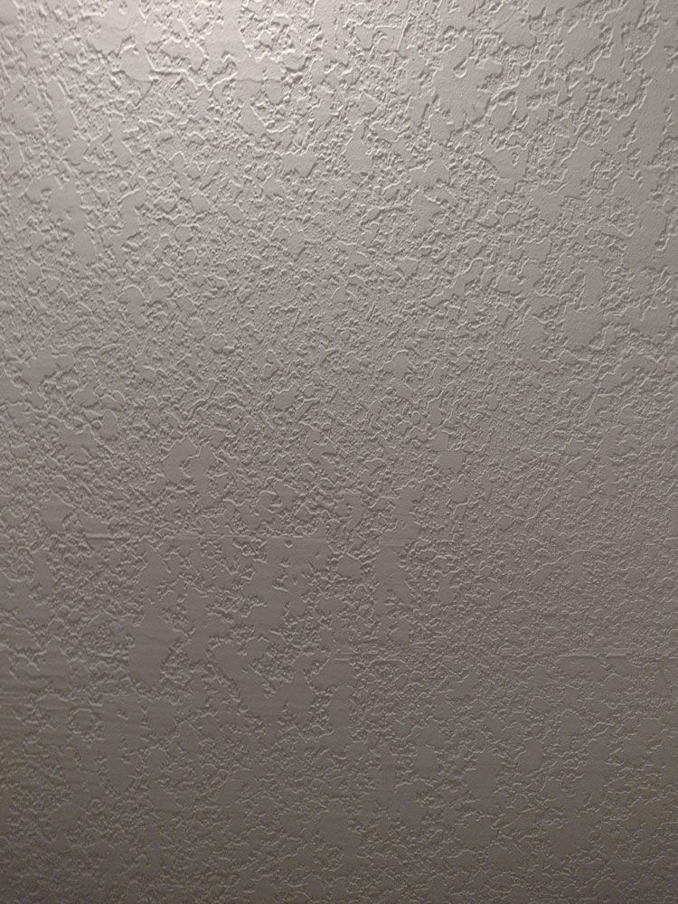 A close up of a white wall with a texture.