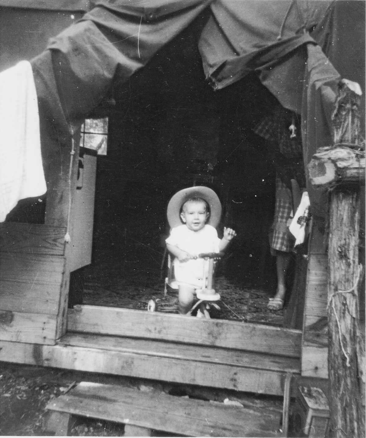 Ronnie Roberts in the family’s tent, 1953