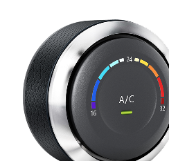 Close-up of a black A/C temperature control knob with colored blue-to-red dial markings.