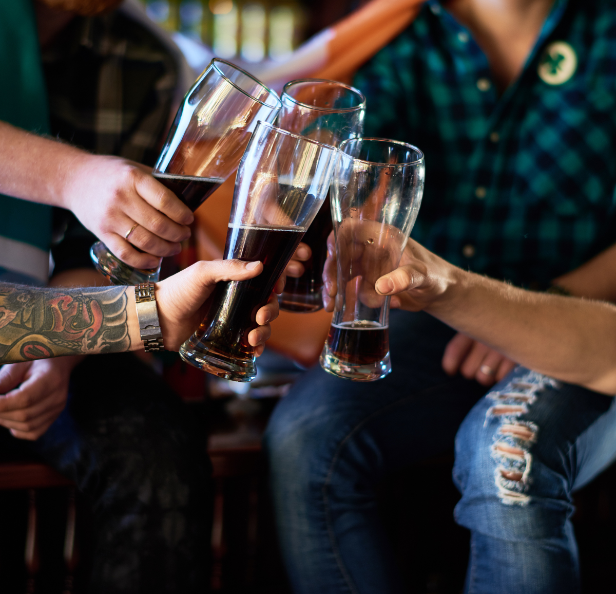 Looney's customers toasting with beer glasses.