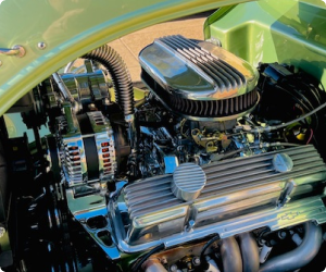 Shiny chrome car engine with a green frame. | Arizona Engine Rebuilding