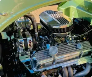 Shiny chrome car engine with a green frame. | Arizona Engine Rebuilding
