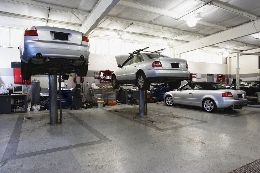 vehicle on an a hydraulic lift in a garage