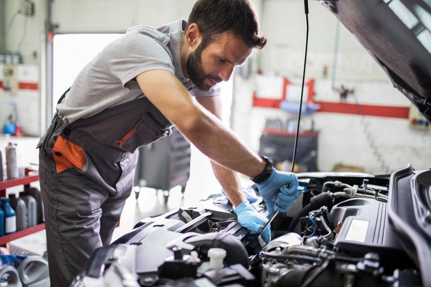 Man working on car engine