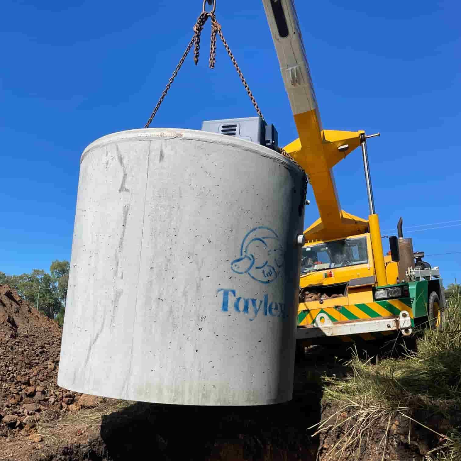 A Large Concrete Cylinder is Being Lifted by a Crane — Rock Plumbing & Gasfitting In Cannonvale, QLD