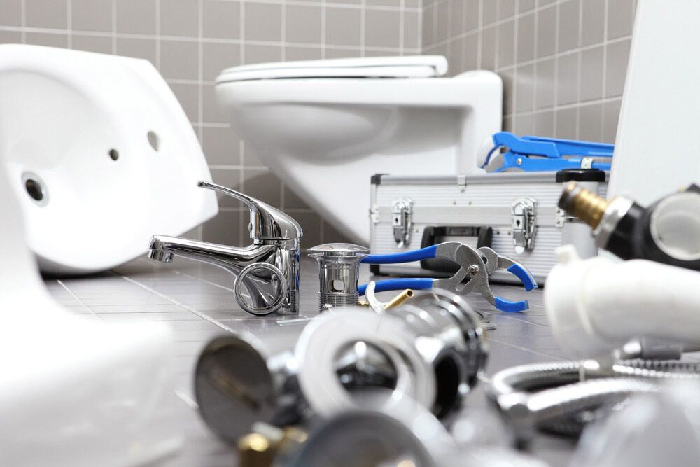 A Bathroom With a Toilet, Sink, and Plumbing Tools on the Floor — Rock Plumbing & Gasfitting In Proserpine, QLD