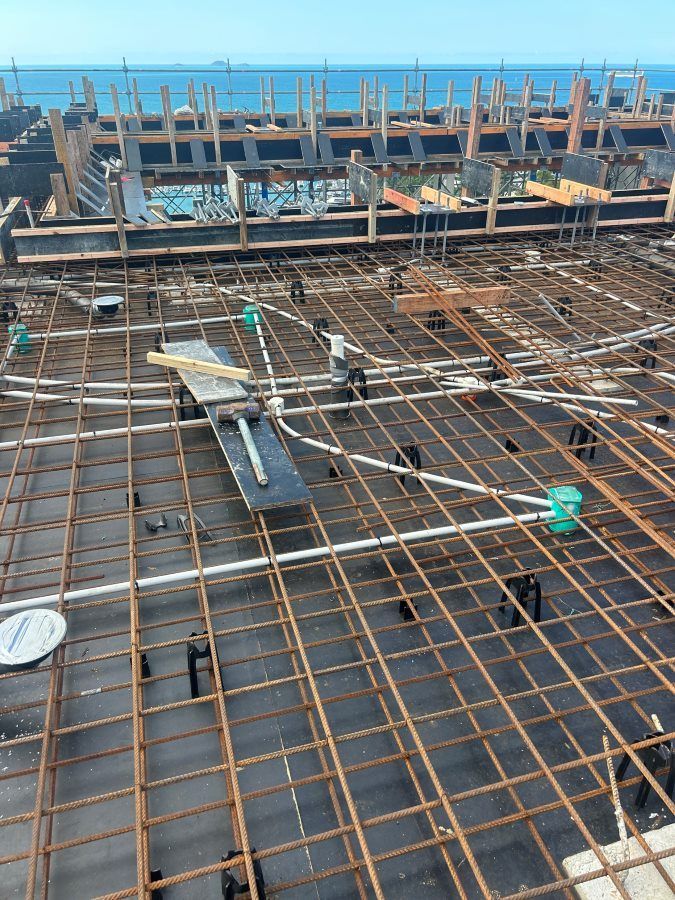 A Building Under Construction With A View Of The Ocean — Rock Plumbing & Gasfitting In Cannonvale, QLD