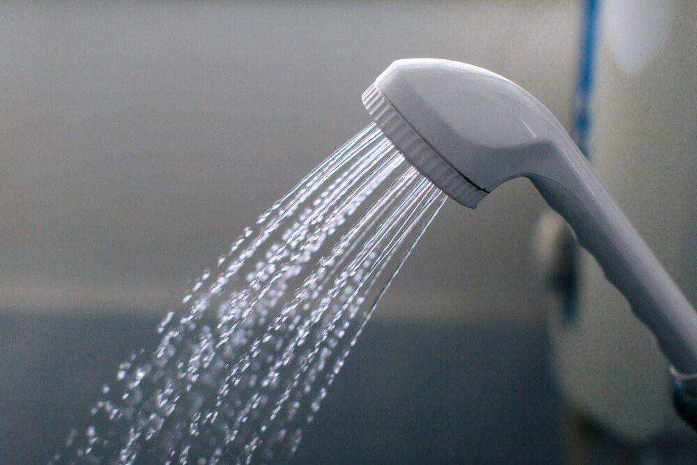 A Shower Head With Water Coming Out of It — Rock Plumbing & Gasfitting In Airlie Beach, QLD