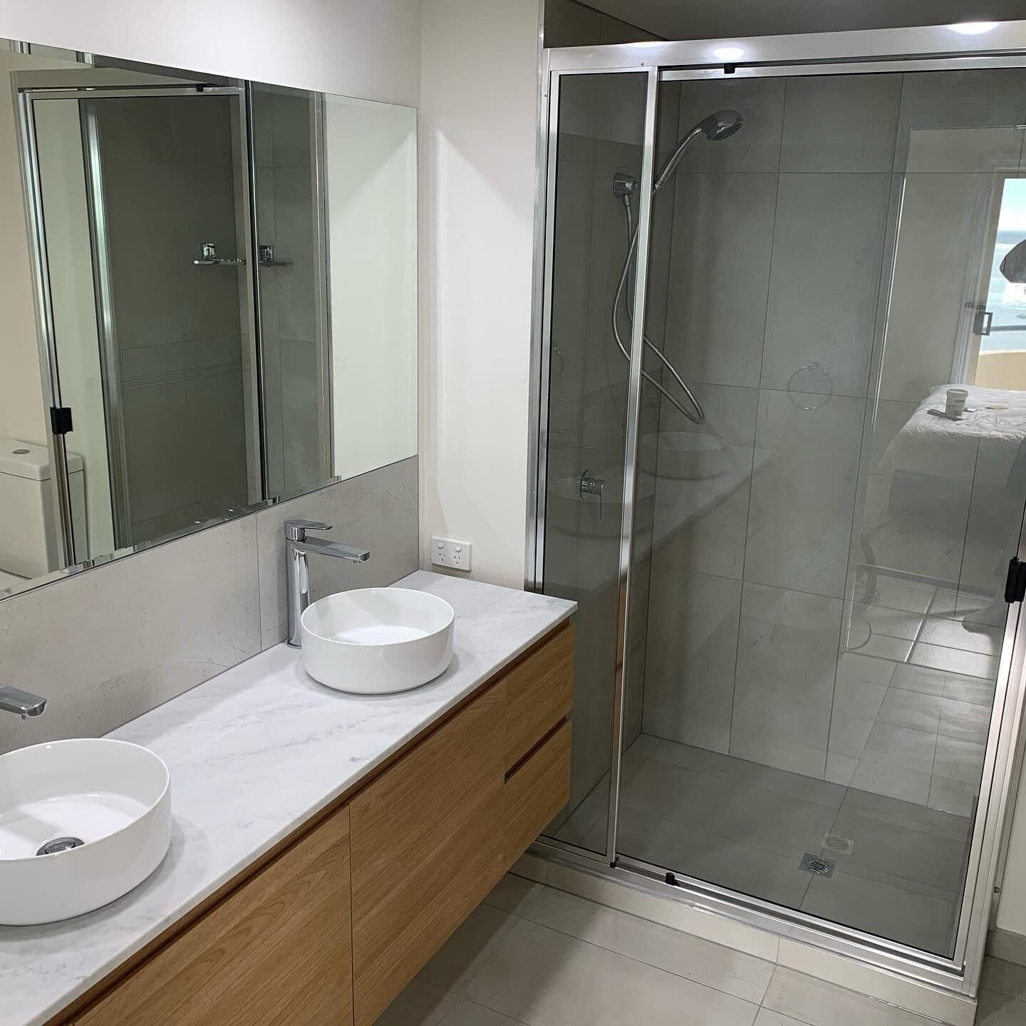 A Bathroom With Two Sinks and a Walk in Shower — Rock Plumbing & Gasfitting In Cannonvale, QLD