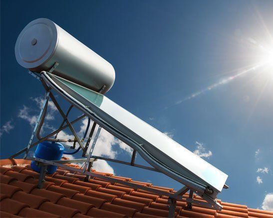 A Solar Water Heater is Sitting on Top of a Tiled Roof — Rock Plumbing & Gasfitting In Cannonvale, QLD