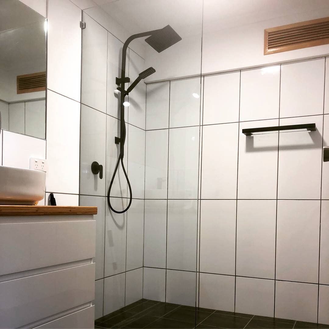 A Bathroom With a Walk in Shower and a Sink — Rock Plumbing & Gasfitting In Cannonvale, QLD