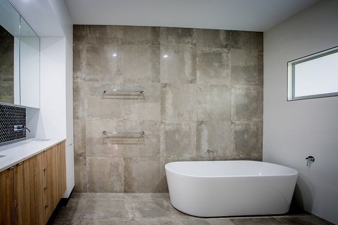 A Bathroom With a Bathtub, Sink, and Shower — Rock Plumbing & Gasfitting In Cannonvale, QLD
