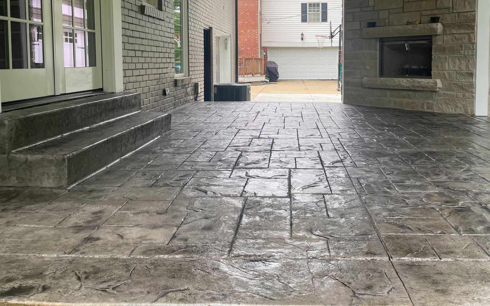 A patio with a fireplace and a flat screen tv