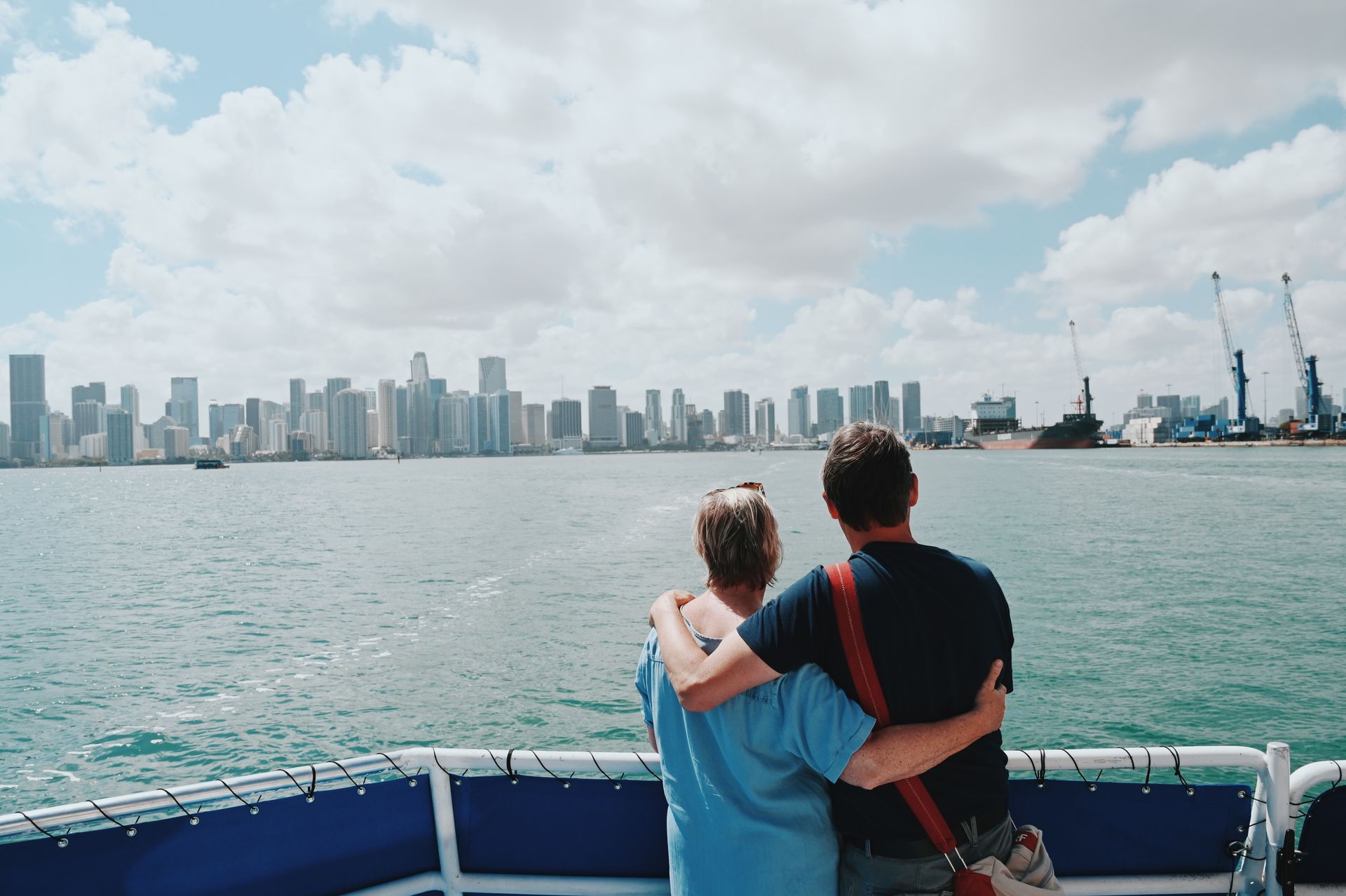 Couple looking at the Miami Skyline from the front of the Miami Boat tour