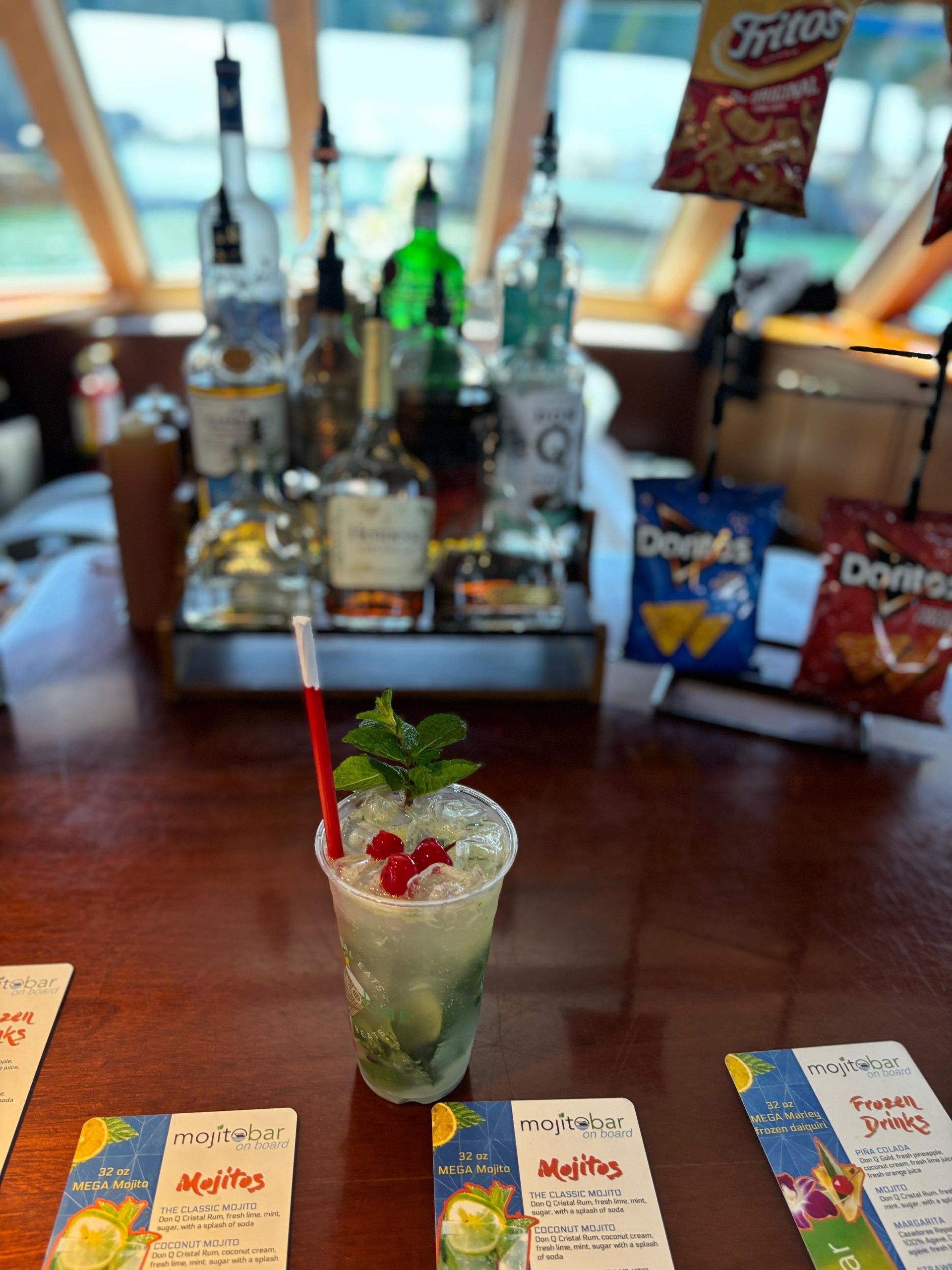 the Mojito Bar on board the Miami boat Tour with a mojito on the table of the cash Bar