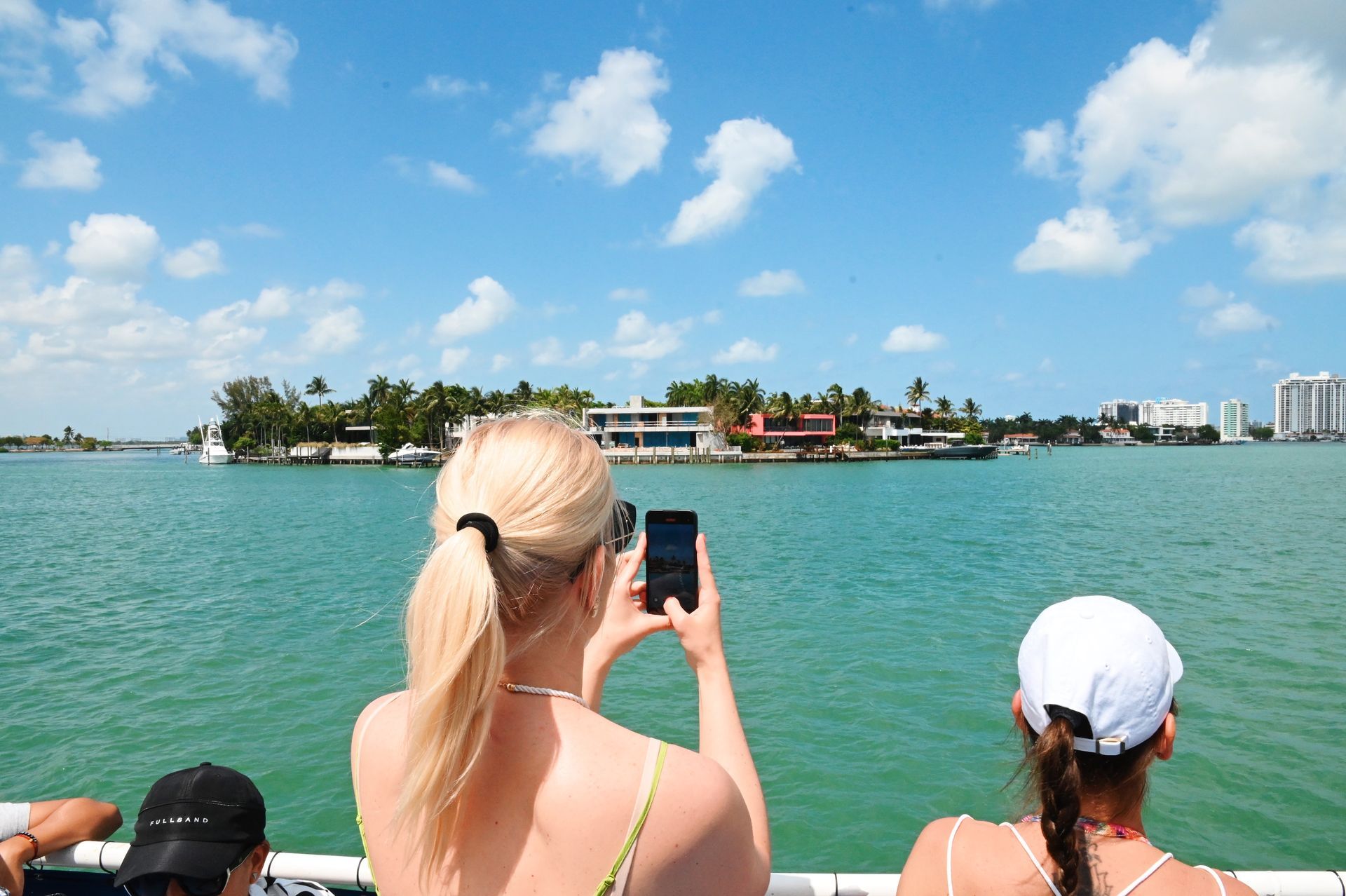Guest taking photos of Celebrity Mansions on the Miami Boat Cruise