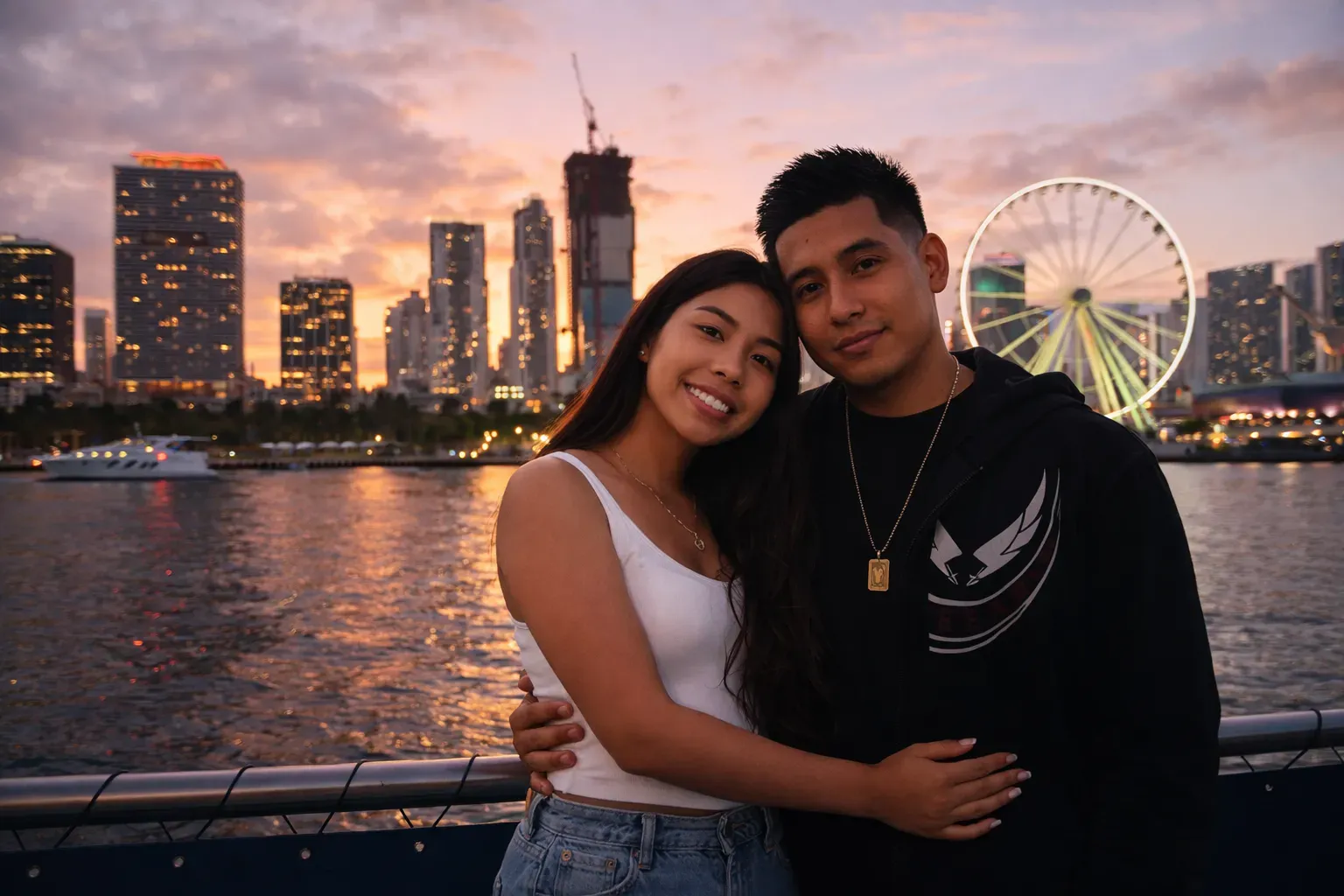 Couple enjoying Miami Sunset Cruises with skyline views and Bayside lights at dusk.
