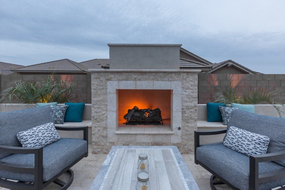There is a fireplace in the middle of the patio.