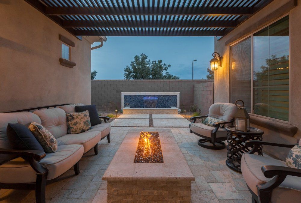 There is a fire pit in the middle of the patio.