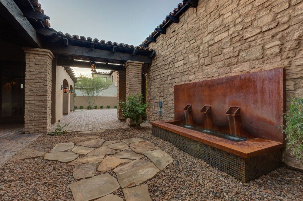 There is a fountain in the middle of the courtyard.