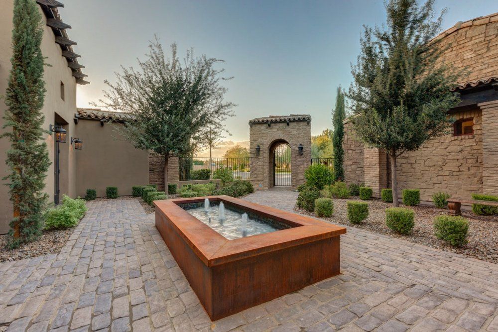 There is a fountain in the middle of the courtyard.