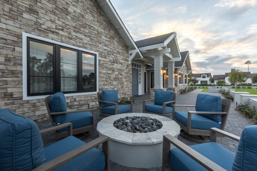 There is a fire pit in the middle of the patio.