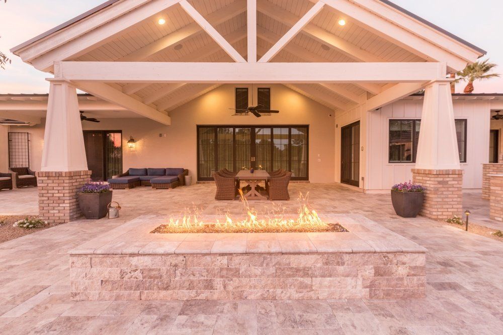A large house with a fire pit in front of it.