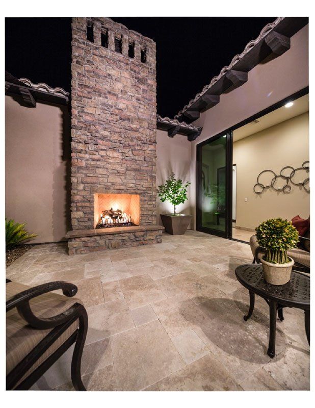 There is a fireplace in the middle of the patio.
