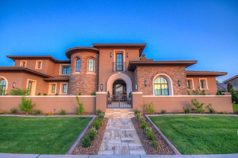 A large house with a stone walkway leading to it.