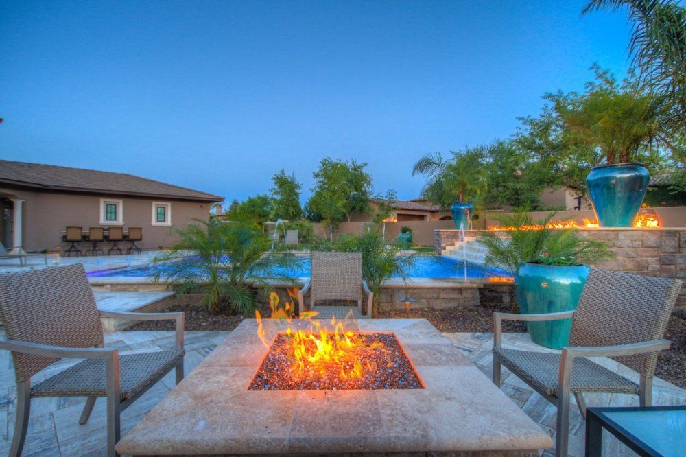 There is a fire pit in the middle of the patio.