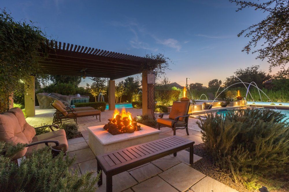 There is a fire pit in the middle of the patio.