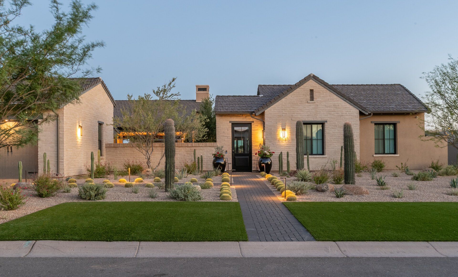 A large house with a lush green lawn in front of it.