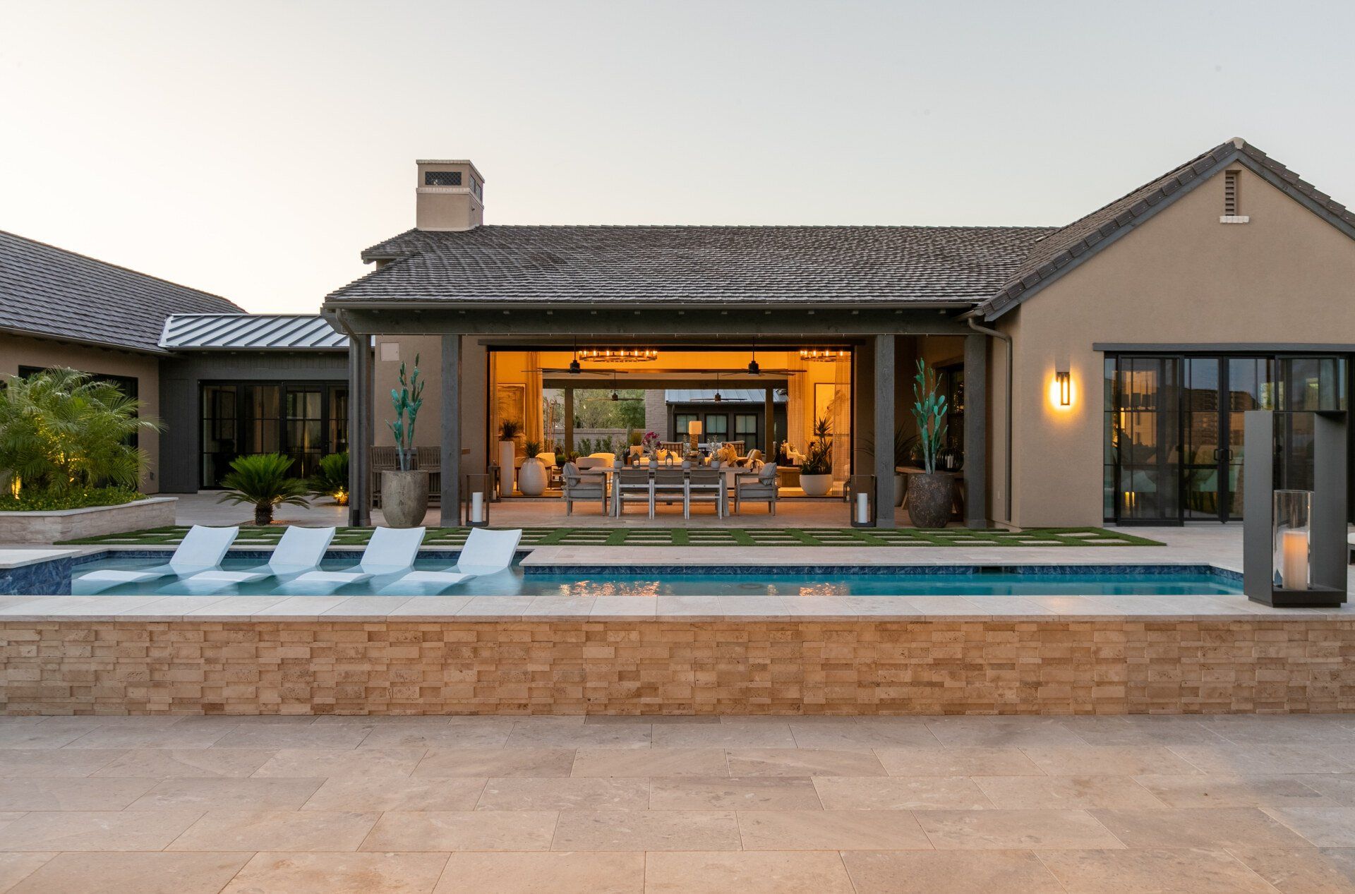 A large house with a large swimming pool in front of it.