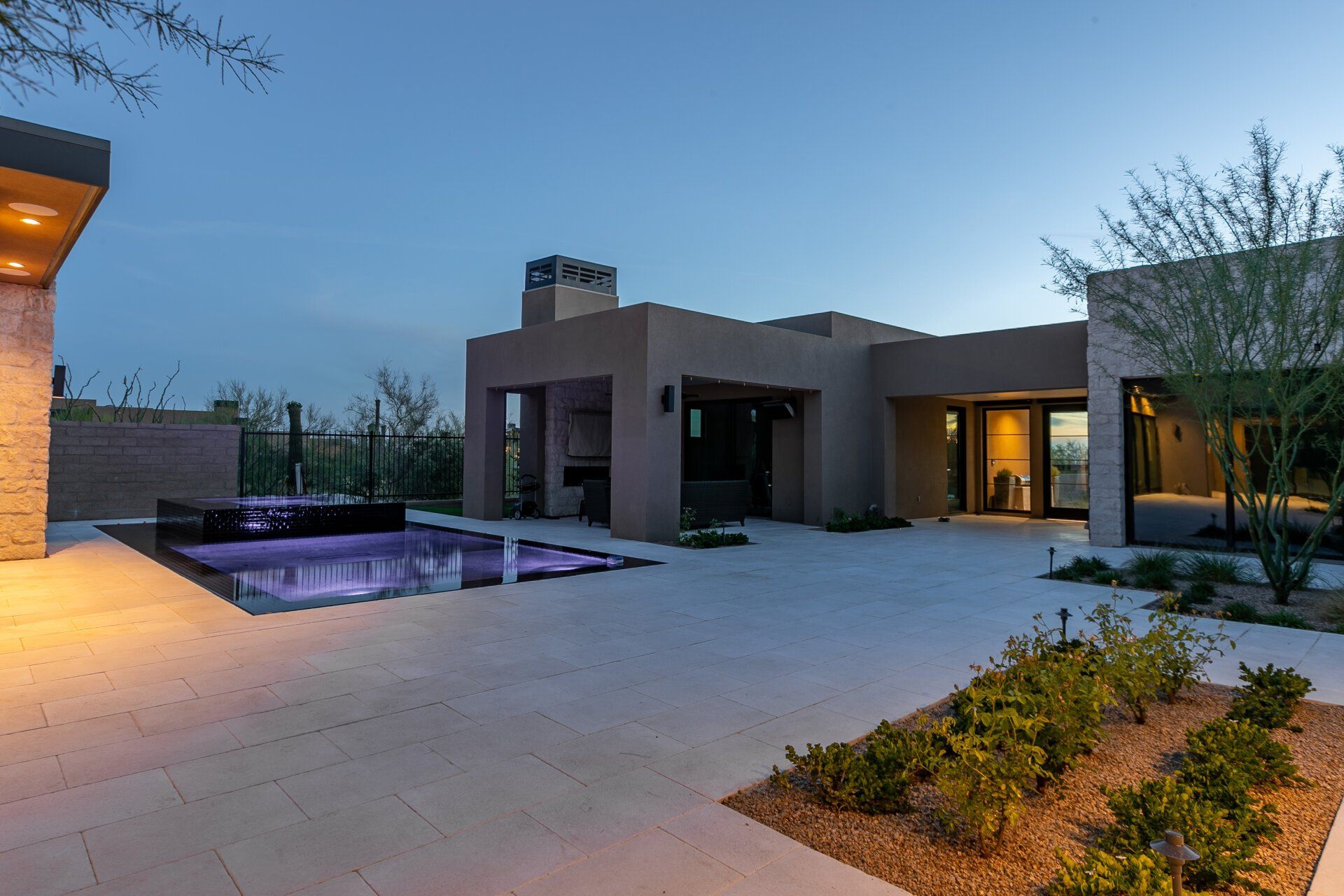 A large house with a swimming pool in front of it.