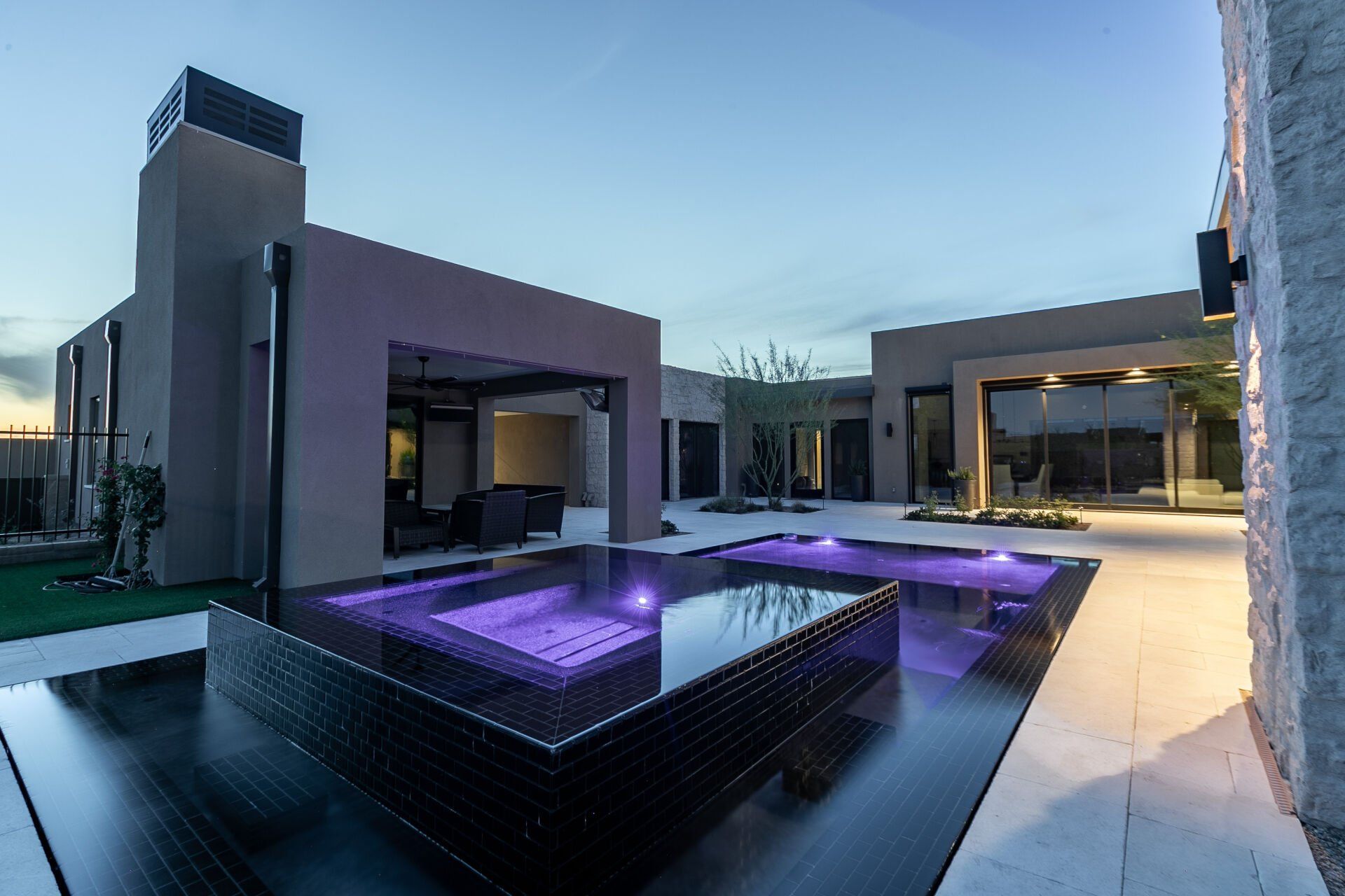 A large house with a large swimming pool in front of it