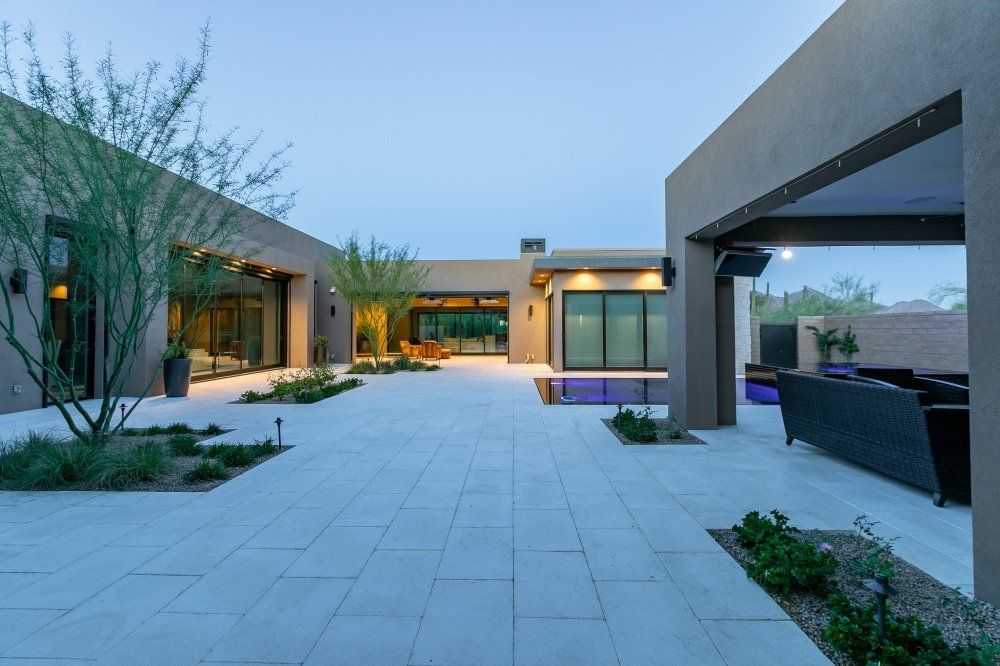 A large house with a patio in the middle of it.