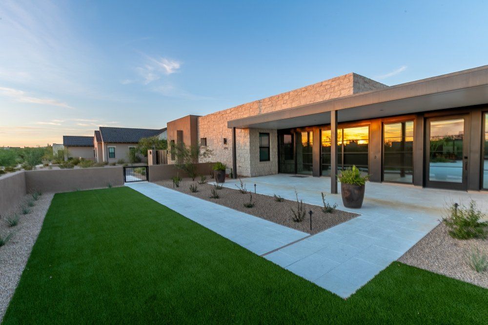 A large house with a large lawn in front of it.