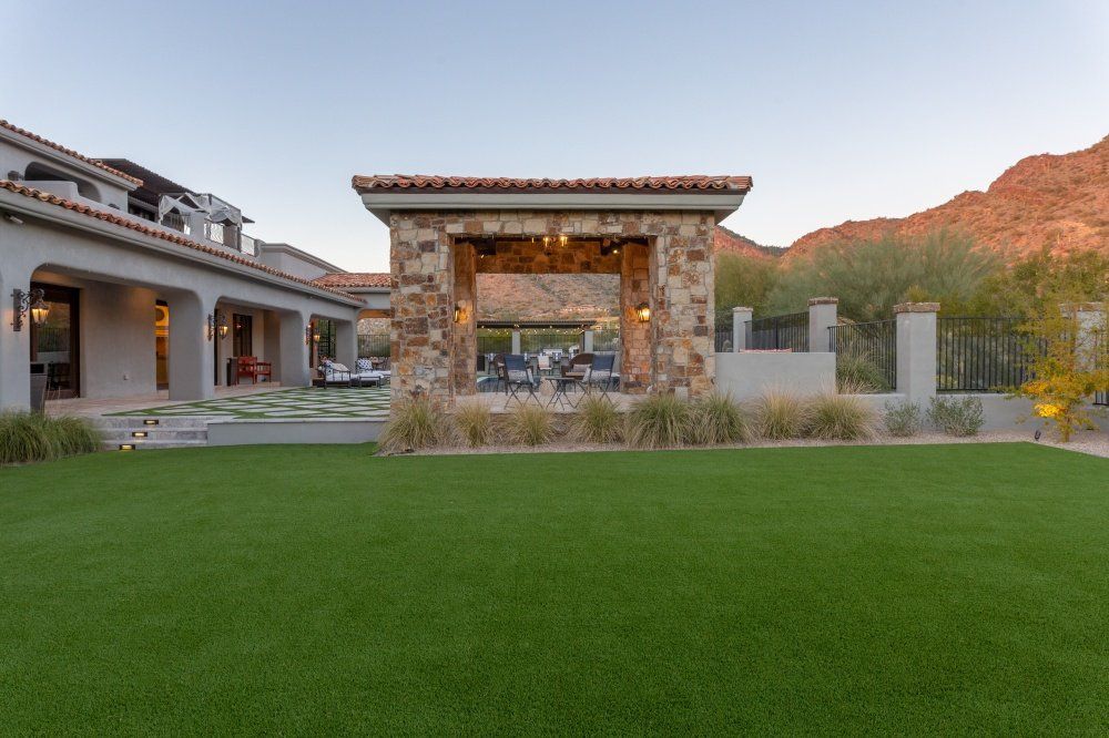 A large house with a large lawn in front of it.