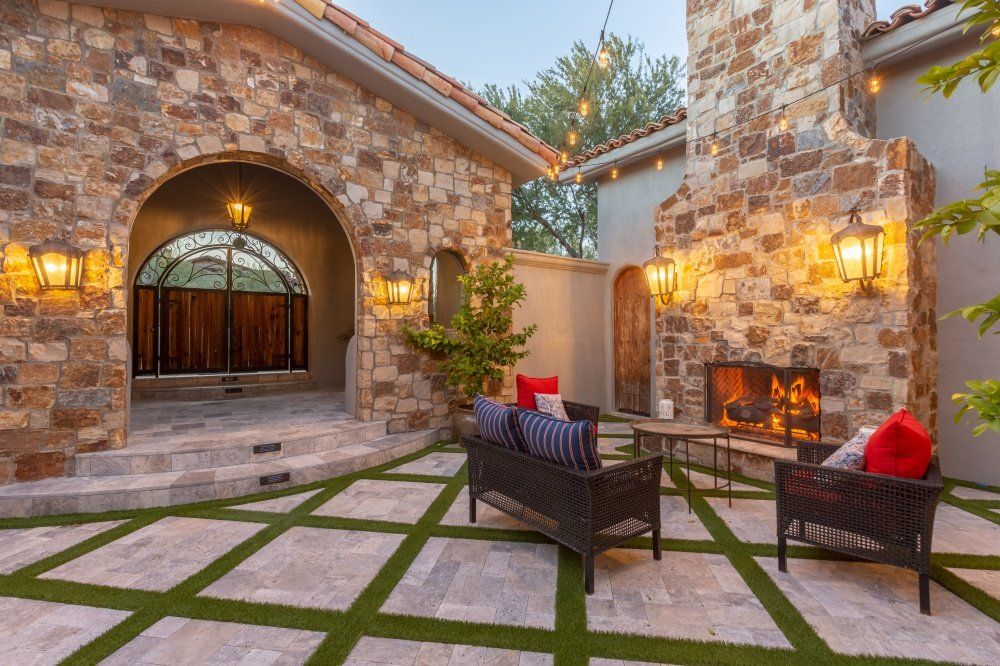 There is a fireplace in the backyard of a house.
