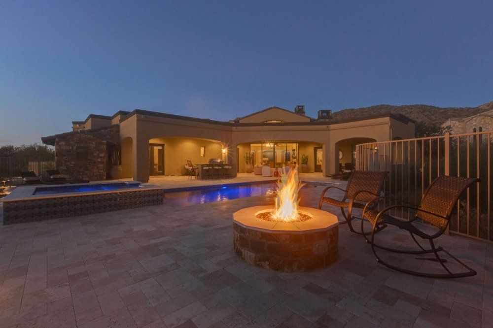 There is a fire pit in the backyard of a house.