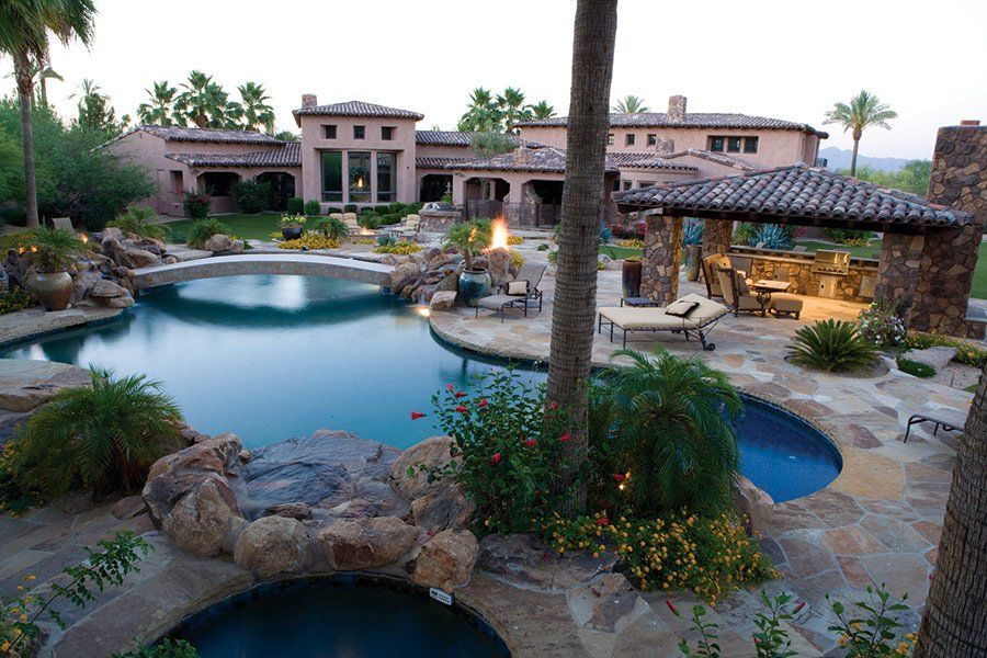 A large house with a large swimming pool in front of it