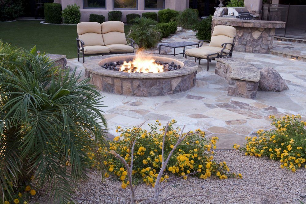 There is a fire pit in the middle of the patio.