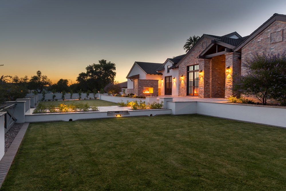 A large house with a large lawn in front of it.